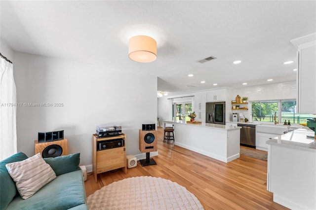 8885 SW 182nd Ter, Palmetto Bay, FL 33157 - living room with light wood-type flooring and recessed lighting