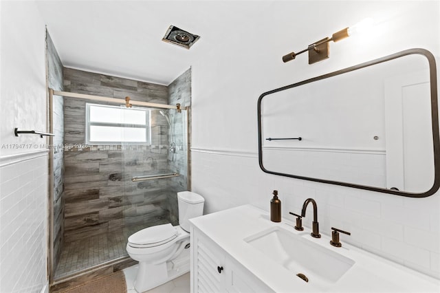 8885 SW 182nd Ter, Palmetto Bay, FL 33157 - bathroom with tile walls, a shower stall, toilet, vanity, and tile patterned flooring