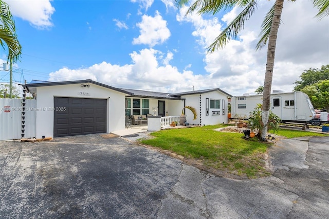 7311 Biltmore Blvd, Miramar, FL 33023 - view of front of house with driveway, an attached garage, and stucco siding