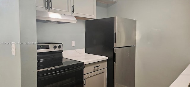 331 N 70th Way, Hollywood, FL 33024 - kitchen featuring electric range, under cabinet range hood, freestanding refrigerator, and light stone countertops