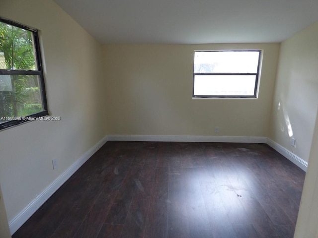 2507 N 66th Ave, Hollywood, FL 33024 - spare room with dark wood-type flooring, healthy amount of natural light, and baseboards