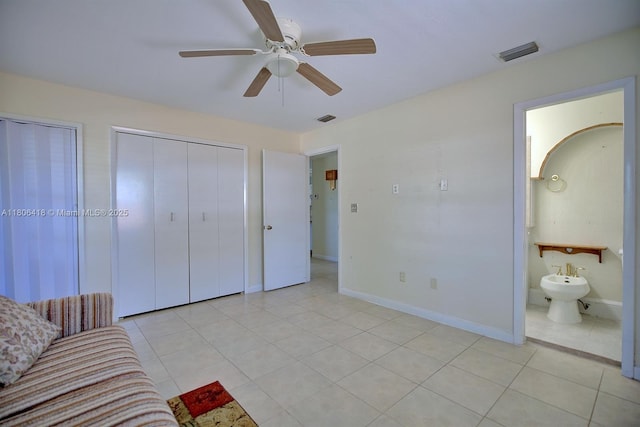 210 Joe Hilton St, Avon Park, FL 33825 - unfurnished bedroom featuring light tile patterned flooring, baseboards, a ceiling fan, multiple closets, and ensuite bathroom