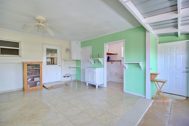 210 Joe Hilton St, Avon Park, FL 33825 - spare room featuring ceiling fan, light tile patterned floors, baseboards, and ornamental molding