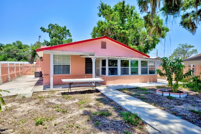 210 Joe Hilton St, Avon Park, FL 33825 - view of front facade with a patio, a fenced backyard, central air condition unit, and stucco siding