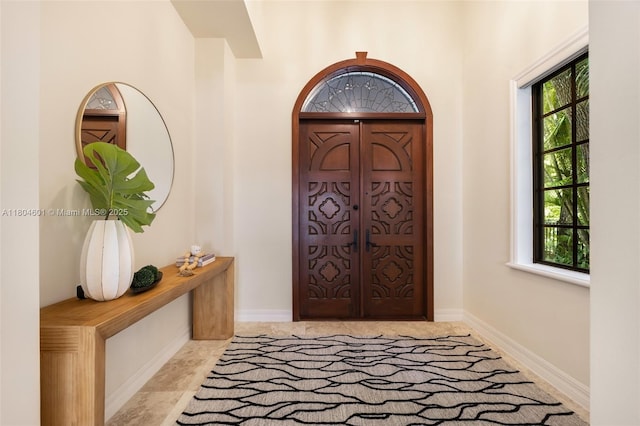 entryway featuring healthy amount of natural light and baseboards