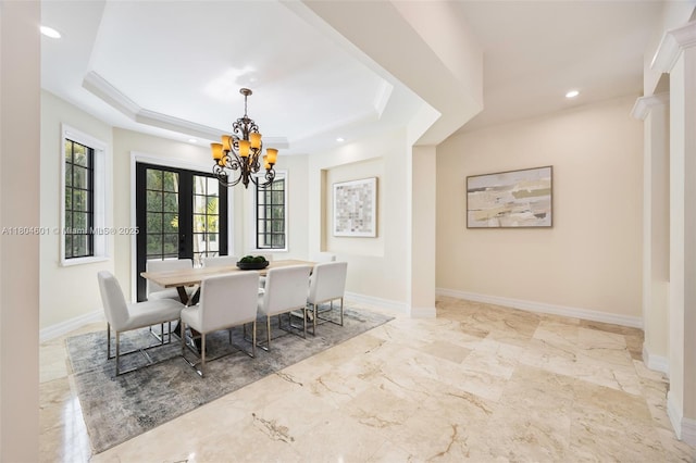dining area featuring a chandelier, a raised ceiling, marble finish floors, recessed lighting, and baseboards