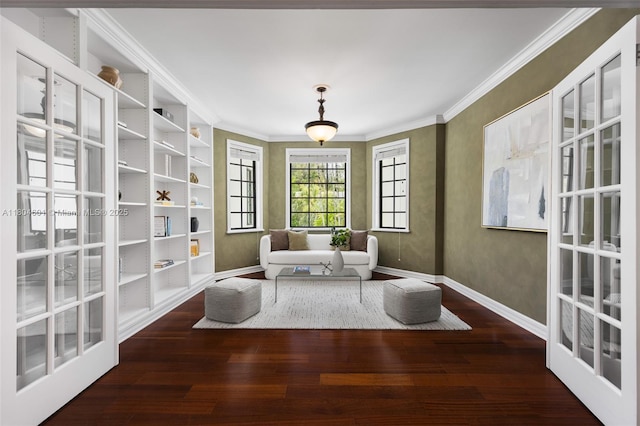 sitting room featuring baseboards, wood finished floors, and ornamental molding