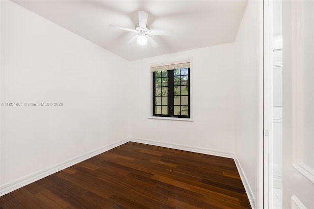 unfurnished room with dark wood-type flooring, baseboards, and a ceiling fan