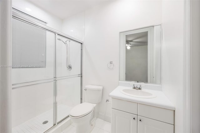 bathroom featuring ceiling fan, a stall shower, toilet, vanity, and tile patterned flooring