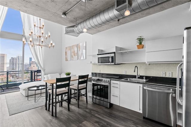 690 SW 1st Ct Unit 2717, Miami, FL 33130 - kitchen with appliances with stainless steel finishes, a sink, dark countertops, dark wood-style floors, and a chandelier