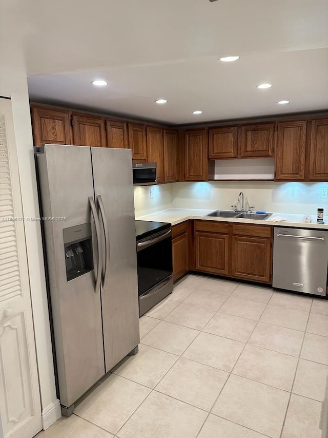 1621 Collins Ave Unit 505, Miami Beach, FL 33139 - kitchen with stainless steel appliances, a sink, light countertops, light tile patterned floors, and recessed lighting