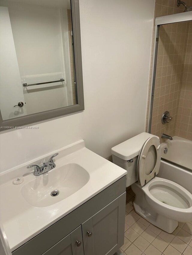 1621 Collins Ave Unit 505, Miami Beach, FL 33139 - bathroom featuring tile patterned floors, toilet, shower / washtub combination, and vanity