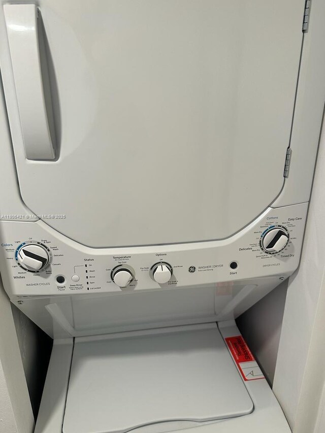 1621 Collins Ave Unit 505, Miami Beach, FL 33139 - laundry room featuring stacked washer / dryer and water heater