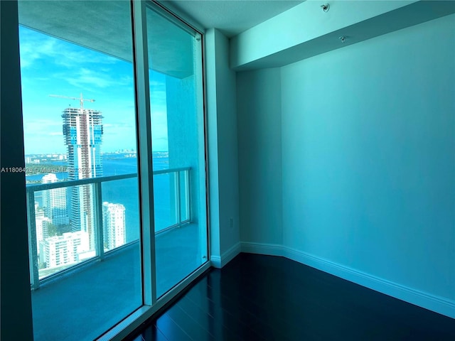 1900 N Bayshore Dr Unit 4708, Miami, FL 33132 - empty room featuring dark wood finished floors and a city view