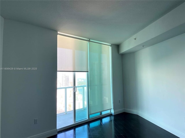 1900 N Bayshore Dr Unit 4708, Miami, FL 33132 - empty room with dark wood-style floors and floor to ceiling windows