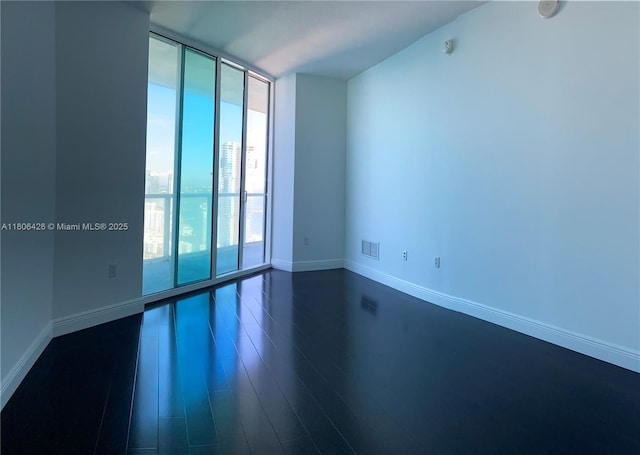 1900 N Bayshore Dr Unit 4708, Miami, FL 33132 - empty room with a wall of windows and dark wood finished floors