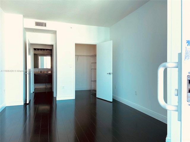 1900 N Bayshore Dr Unit 4708, Miami, FL 33132 - unfurnished bedroom featuring dark wood finished floors, a spacious closet, and a closet
