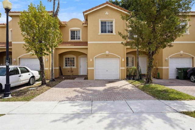 355 SE 20th Ter, Homestead, FL 33033 - view of front of house featuring decorative driveway, stucco siding, a tile roof, and a garage