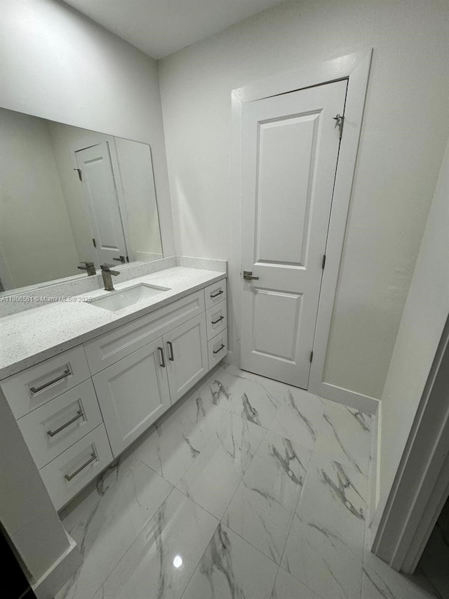 940 SW 78th Pl, Miami, FL 33144 - bathroom featuring vanity and marble look tiles