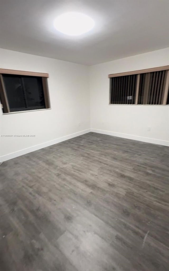 940 SW 78th Pl, Miami, FL 33144 - spare room with dark wood-style flooring and baseboards