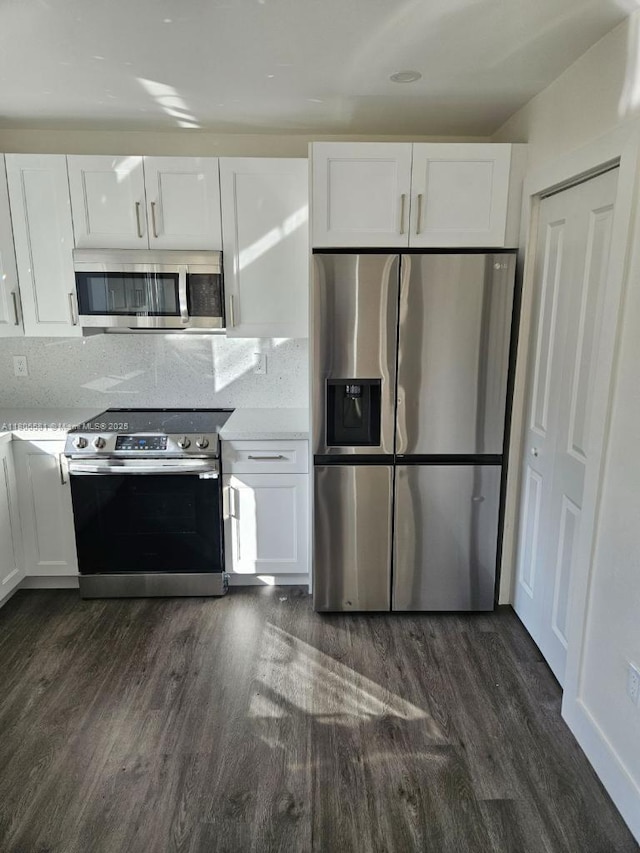 940 SW 78th Pl, Miami, FL 33144 - kitchen featuring stainless steel appliances, dark wood-style floors, and white cabinets