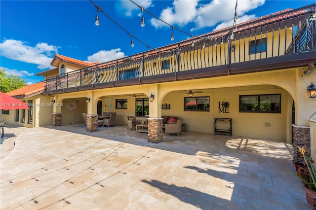 11915 Green Oak Dr, Davie, FL 33330 - rear view of house featuring a balcony, a ceiling fan, stucco siding, a patio area, and outdoor dining space