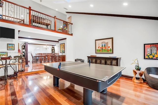 11915 Green Oak Dr, Davie, FL 33330 - game room featuring wood finished floors, arched walkways, crown molding, a high ceiling, and recessed lighting