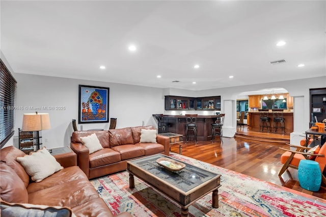 11915 Green Oak Dr, Davie, FL 33330 - living area featuring arched walkways, bar, wood finished floors, and recessed lighting