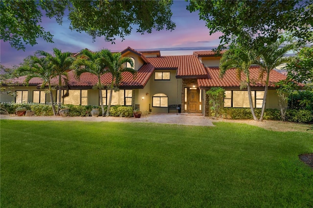 11915 Green Oak Dr, Davie, FL 33330 - view of front facade with a tile roof, a front lawn, and stucco siding