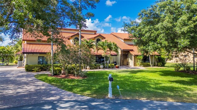 11915 Green Oak Dr, Davie, FL 33330 - mediterranean / spanish-style home featuring a tile roof and a front yard