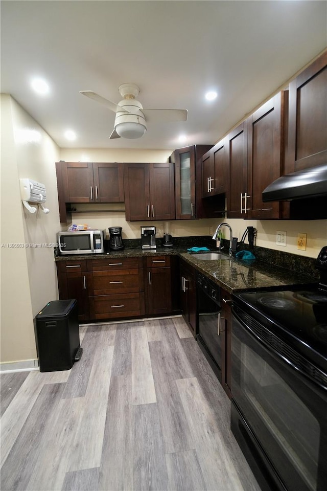 2821NE163RDST N Miami Beach Blvd Unit 4X, North Miami Beach, FL 33160 - kitchen with black appliances, a sink, ventilation hood, dark brown cabinetry, and dark stone counters