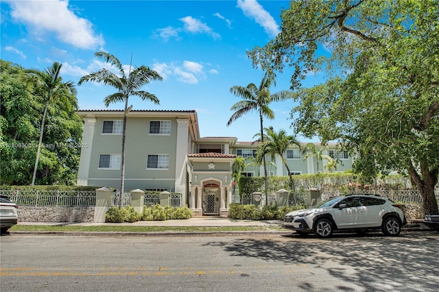 45 Antilla Ave Unit 1G, Coral Gables, FL 33134 - view of front of property featuring a fenced front yard, stucco siding, and a tiled roof
