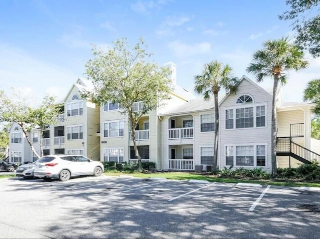1055 S Hiawassee Rd Unit 2014, Orlando, FL 32835 - view of property with uncovered parking and central AC unit
