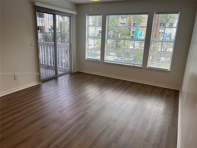 1055 S Hiawassee Rd Unit 2014, Orlando, FL 32835 - unfurnished room with dark wood-style flooring and baseboards