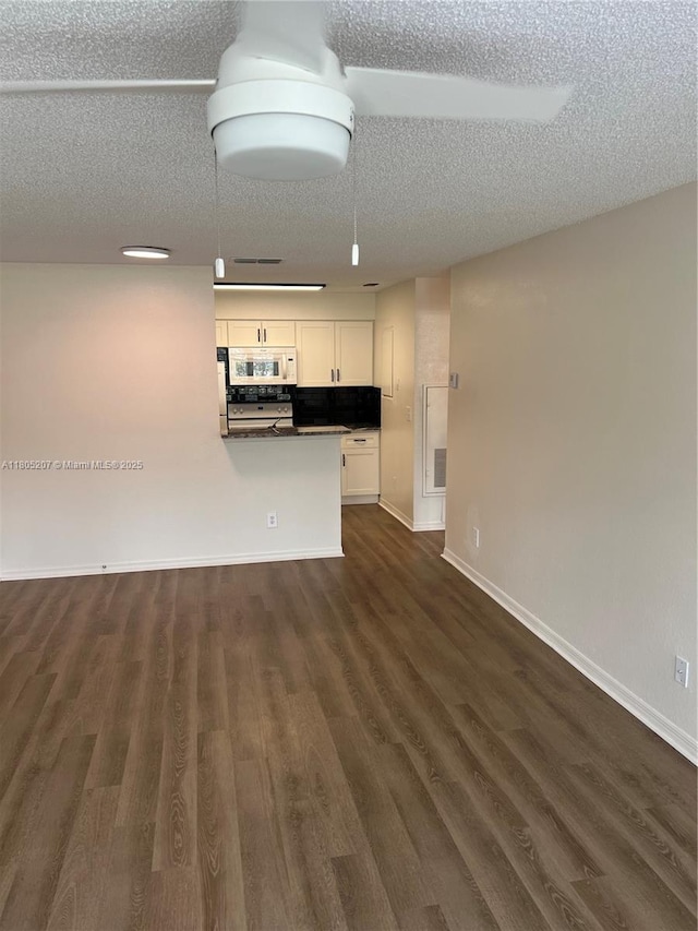 1055 S Hiawassee Rd Unit 2014, Orlando, FL 32835 - unfurnished living room with dark wood finished floors, a textured ceiling, and baseboards