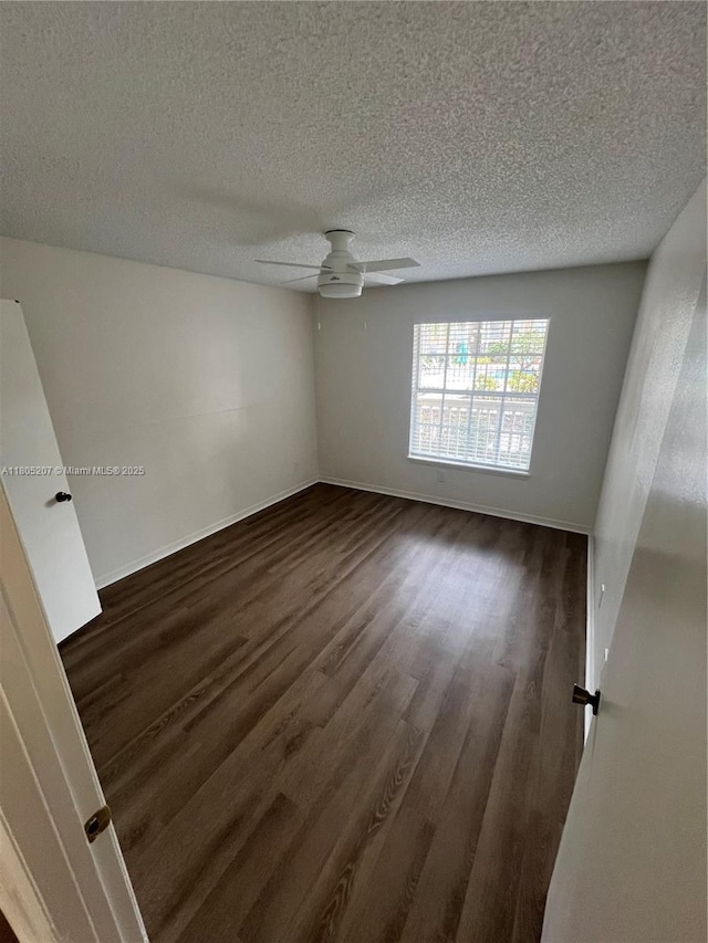 1055 S Hiawassee Rd Unit 2014, Orlando, FL 32835 - spare room with dark wood-style floors, a textured ceiling, a ceiling fan, and baseboards