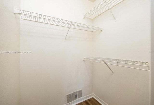 1055 S Hiawassee Rd Unit 2014, Orlando, FL 32835 - walk in closet featuring dark wood-style flooring
