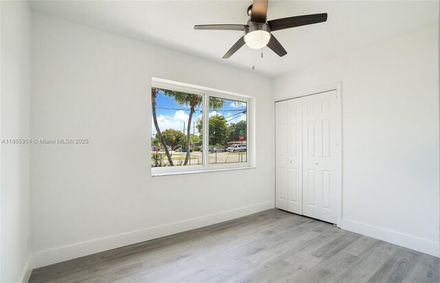 919 NW 13th St, Fort Lauderdale, FL 33311 - unfurnished bedroom with baseboards, wood finished floors, a closet, and ceiling fan