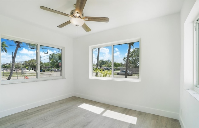 919 NW 13th St, Fort Lauderdale, FL 33311 - spare room with plenty of natural light, baseboards, light wood-style floors, and ceiling fan