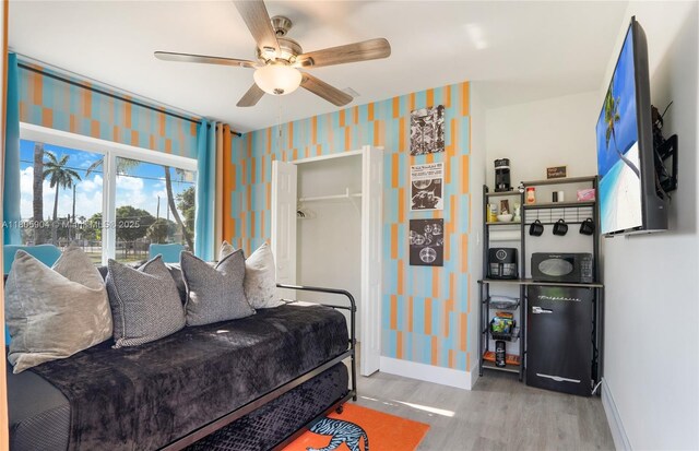 919 NW 13th St, Fort Lauderdale, FL 33311 - living room featuring wallpapered walls, wood finished floors, baseboards, and a ceiling fan