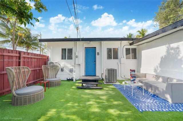 919 NW 13th St, Fort Lauderdale, FL 33311 - rear view of house with central AC unit and stucco siding