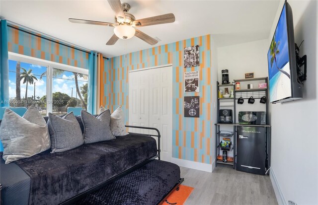 919 NW 13th St, Fort Lauderdale, FL 33311 - living room with wood finished floors, baseboards, wallpapered walls, and a ceiling fan