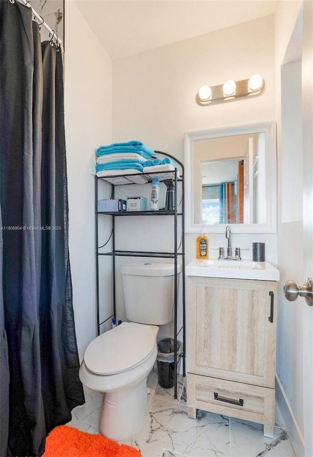 919 NW 13th St, Fort Lauderdale, FL 33311 - bathroom with marble look tiles, toilet, vanity, a shower with shower curtain, and baseboards