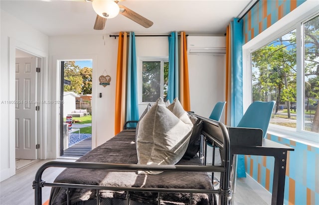 919 NW 13th St, Fort Lauderdale, FL 33311 - bedroom with access to exterior, a wall unit AC, and wood finished floors