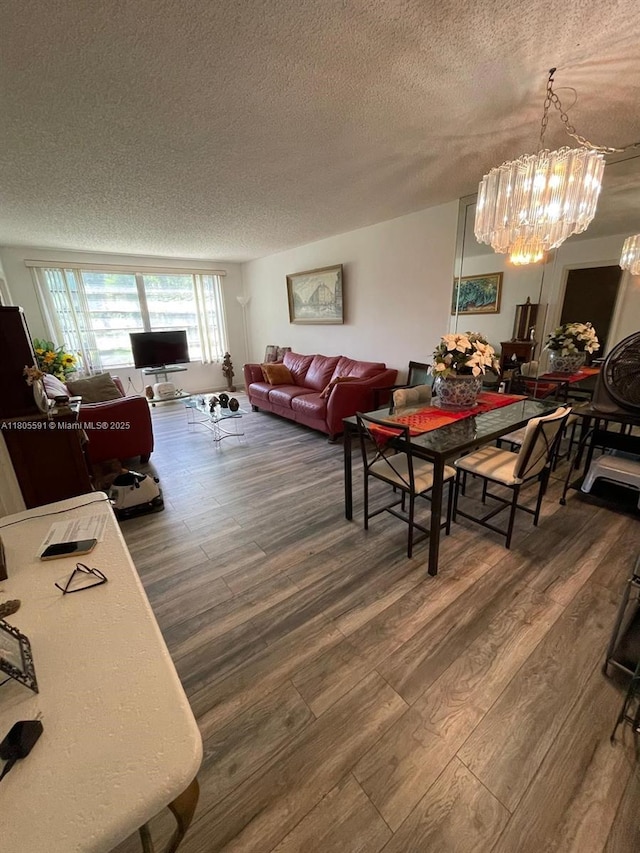 7400 NW 17th St Unit 209, Plantation, FL 33313 - dining space featuring a textured ceiling, wood finished floors, and a chandelier