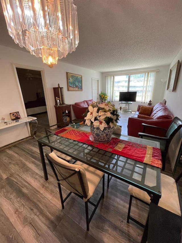 7400 NW 17th St Unit 209, Plantation, FL 33313 - dining area featuring a chandelier, a textured ceiling, and wood finished floors