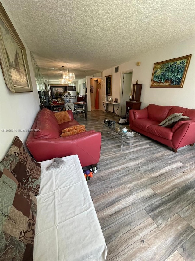 7400 NW 17th St Unit 209, Plantation, FL 33313 - living area with a textured ceiling, wood finished floors, and a chandelier