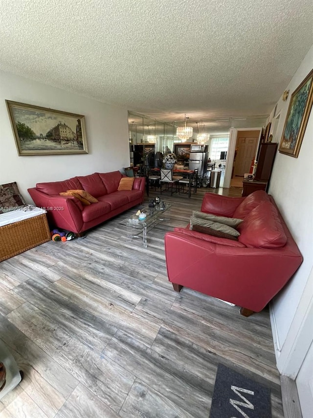 7400 NW 17th St Unit 209, Plantation, FL 33313 - living room with a textured ceiling, wood finished floors, and a chandelier