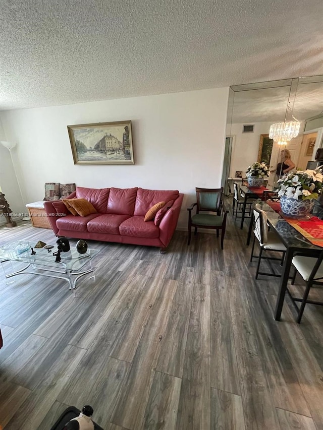 7400 NW 17th St Unit 209, Plantation, FL 33313 - living area with wood finished floors, a textured ceiling, and a chandelier