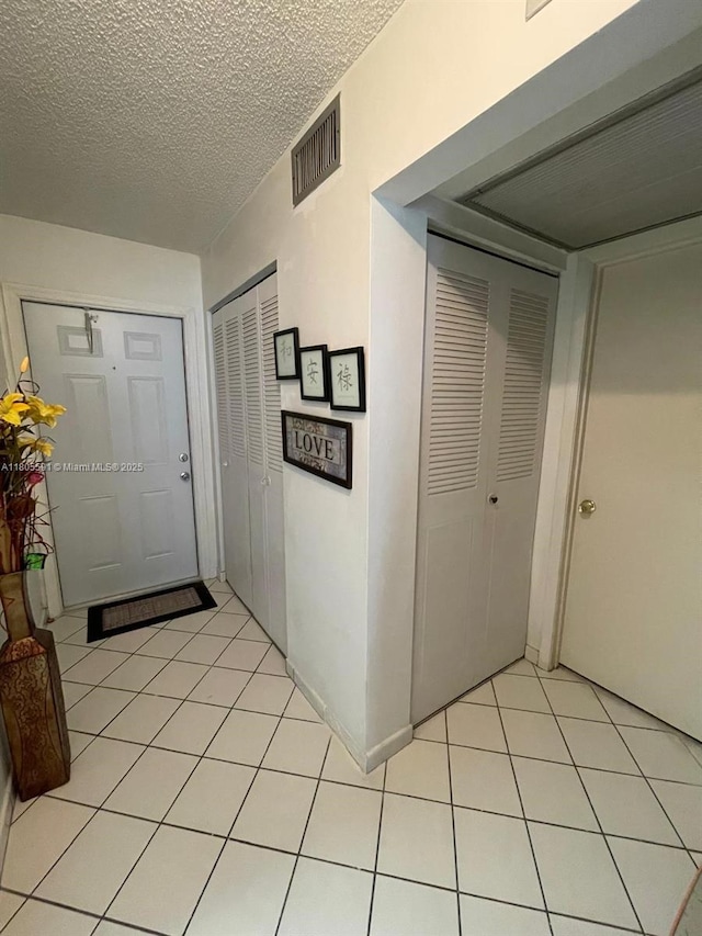 7400 NW 17th St Unit 209, Plantation, FL 33313 - foyer with light tile patterned floors and a textured ceiling